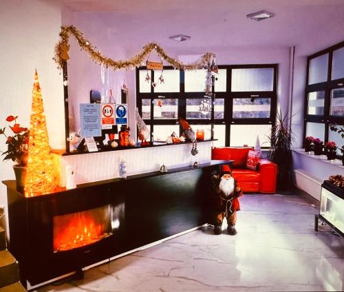 a living room with a fireplace and a christmas tree at Casa Vinga in Poiana Brasov