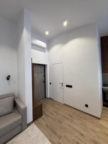 a living room with a couch and a door at Pysanka apartments in Kolomyya