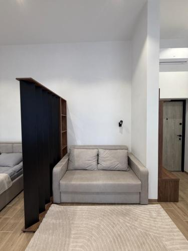 a living room with a couch and a bed at Pysanka apartments in Kolomyya