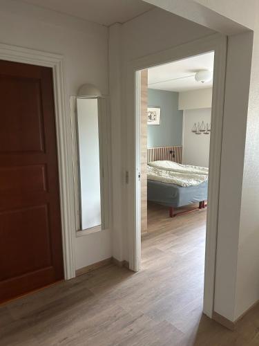 a room with a bedroom with a bed and a mirror at Marienlyst Apartment in Helsingør