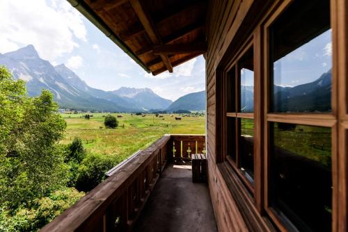 a view from a house window with mountains in the background at Mellow Mountain Hostel in Ehrwald