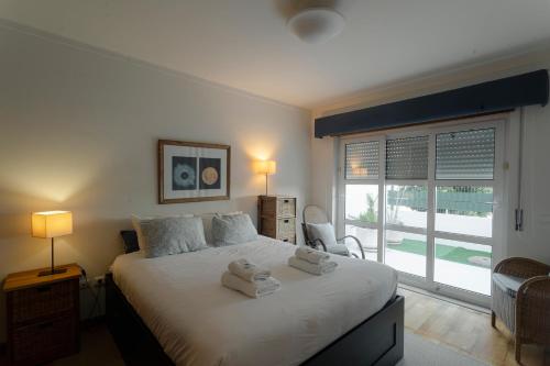 a bedroom with a large bed with towels on it at Best Houses 40 - You me and the sea in Ferrel
