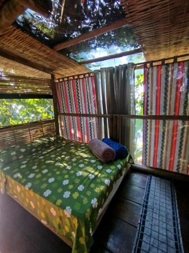 a bedroom in a tree house with a bed at Filhas da Terra Jaguanum in Itacuruçá
