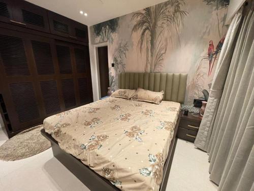 a bedroom with a bed and a painting on the wall at Airnest Stays- Bohemian in Mumbai