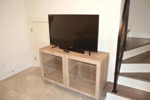 a flat screen tv sitting on top of a wooden cabinet at Quaint Home 310C - minutes from Uptown Charlotte in Charlotte