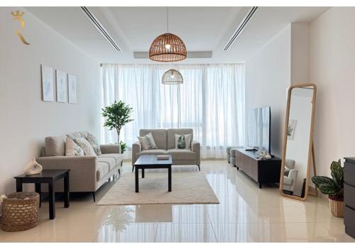 a living room with a couch and a mirror at Al Reem 2BR - Stylish Family Retreat in Abu Dhabi