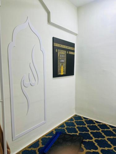a room with a staircase with a picture on the wall at Ruma Shinkou in Kota Tinggi