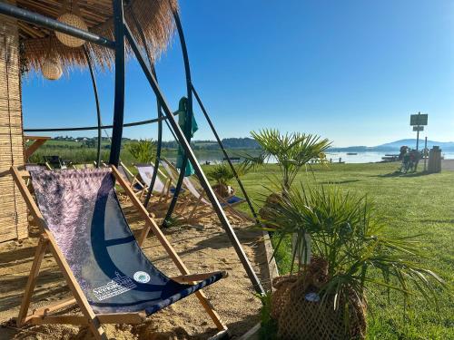 a blue chair in the sand near a beach at "SONNTAGSKIND" - 2-Zimmer-Apartment mit Terrasse und Privatgarten in Kraiham