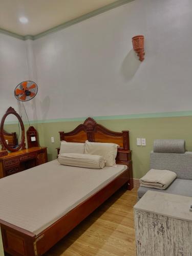 a bedroom with two beds and a table and a mirror at Duy Anh Hotel Biên Hoà in Bien Hoa