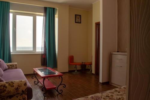 a living room with a couch and a table at ElStefanino House in Eforie Nord