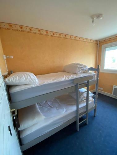 two bunk beds in a room with a window at Location au pied du circuit in Le Mans