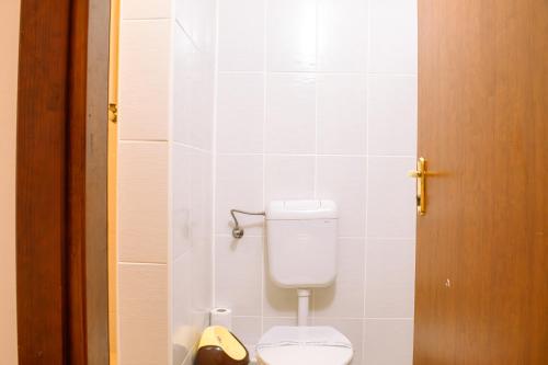 a bathroom with a white toilet in a stall at ElStefanino House in Eforie Nord