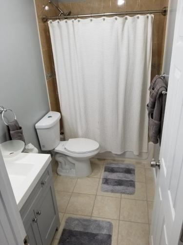 a bathroom with a toilet and a shower curtain at Gigi's luxurious Arora Hills 2 BdRm, 2 Baths Apt in Clarksburg