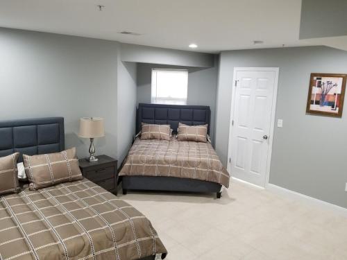 a bedroom with two beds and a window at Gigi's luxurious Arora Hills 2 BdRm, 2 Baths Apt in Clarksburg