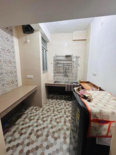a room with a bed and a bench in it at The Hp 39 House in Dharmsala