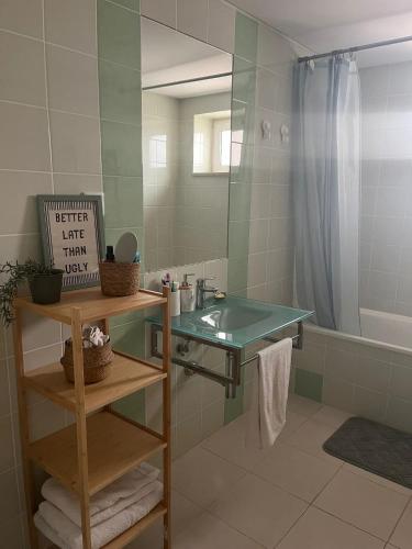 a bathroom with a sink and a mirror and a tub at Cabanas De Miramar in Tavira