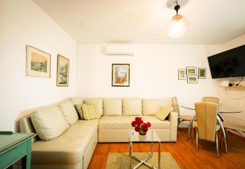 a living room with a couch and a table at Holiday Home Nina Petrinja in Petrinja