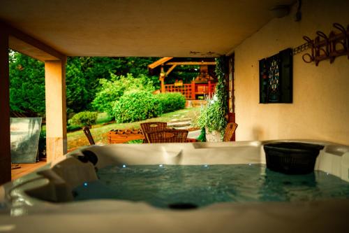a bath tub with a view of a garden at Holiday Home Nina Petrinja in Petrinja