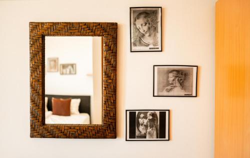 a mirror hanging on a wall with framed pictures at Holiday Home Nina Petrinja in Petrinja