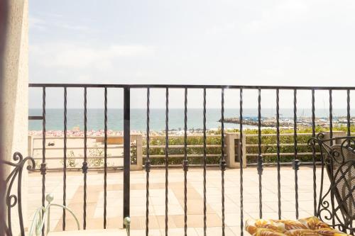 a balcony with a view of the beach at ElStefanino House in Eforie Nord