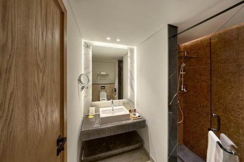 a bathroom with a sink and a mirror at The G Einbay Golf Resort in Ain Sokhna
