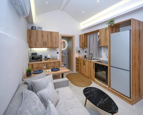 a kitchen with a couch and a white refrigerator at La casa di Antonio Corfu in Alepou