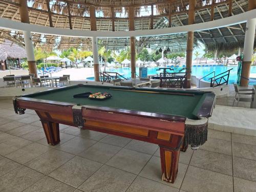 a pool table in a building with a swimming pool at Beach Apartment At Nikki Residences 2 Bedroom in El Chirú