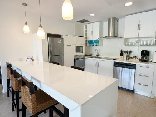 a white kitchen with a large white counter top at Beach Apartment At Nikki Residences 2 Bedroom in El Chirú