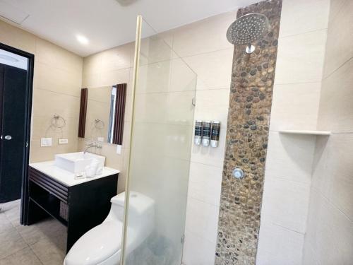 a bathroom with a shower and a toilet and a sink at Beach Apartment At Nikki Residences 2 Bedroom in El Chirú
