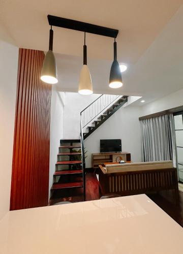 a living room with two lights and a staircase at Eleanor Homestay Dieng in Dieng