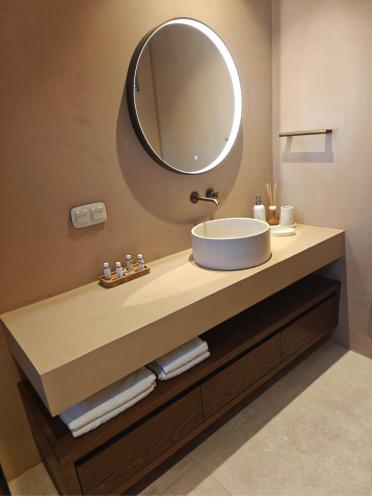 a bathroom sink with a large mirror above it at Locanda in Monemvasia