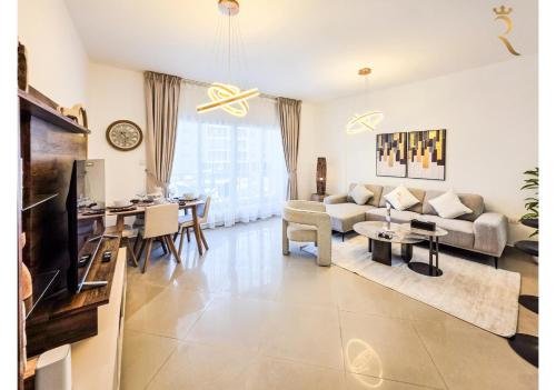 a living room with a couch and a table at Modern 1BR - Poolside & Gym Escape in Abu Dhabi