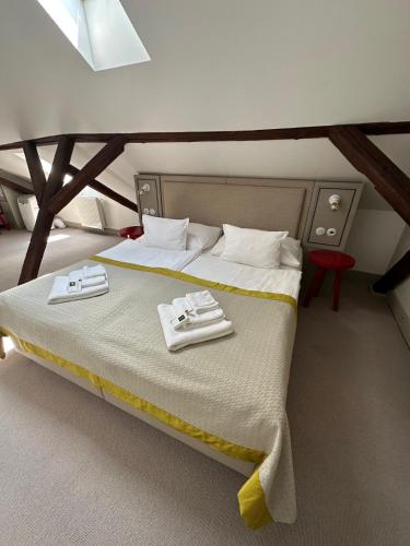 a bedroom with a bed with two towels on it at Hotel Kocour in Třebíč
