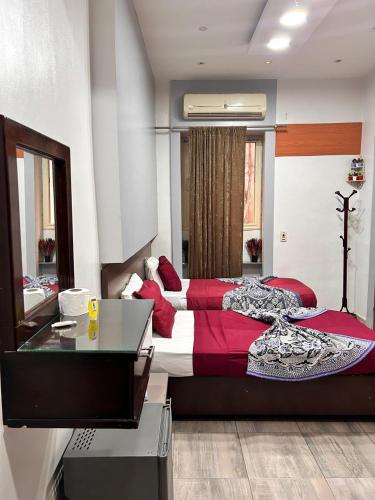 a bedroom with a large bed and a desk at the Hotel Emerald in Cairo