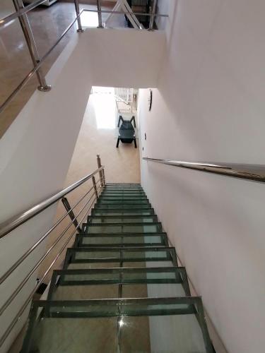 a staircase in an office building with a stair case at دوبليكس ميرامار مرتيل in Martil