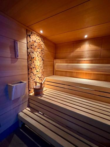 a wooden sauna with a bench in a room at Boutique & Wellnesshotel Thalmässing in Thalmässing