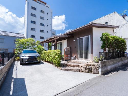 a car parked in the driveway of a house at 88kawaramachi 一軒家 in Takamatsu