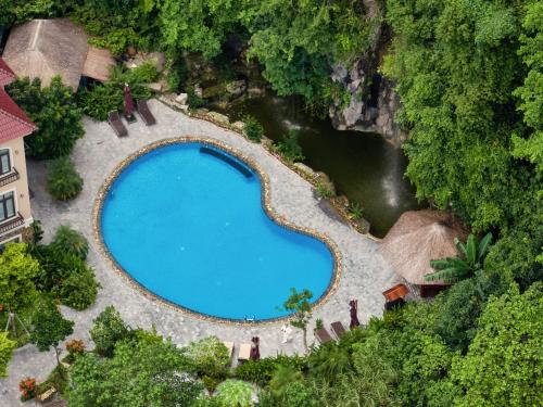 an overhead view of a swimming pool next to a river at Indochine Boutique Hotel Ninh Bình in Ninh Binh