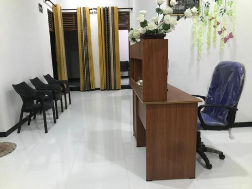 a salon with chairs and a table with flowers on it at Ops Poinix Hotel in Weerawila