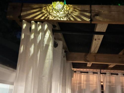 a chandelier hanging from a ceiling with curtains at Crystal Serenity Quartz Soak The Namaste Studio On Lake Hamilton in Hot Springs