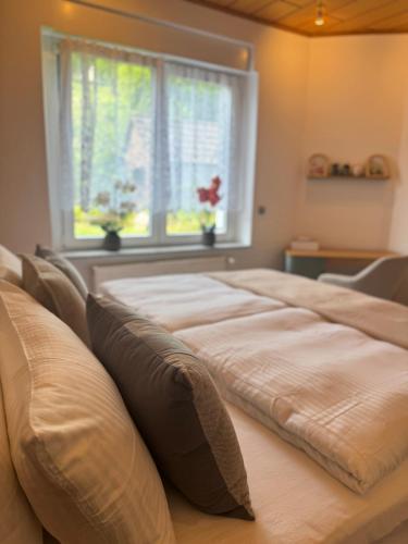 a large bed in a room with a window at Mahesars Home 2 in Ennepetal