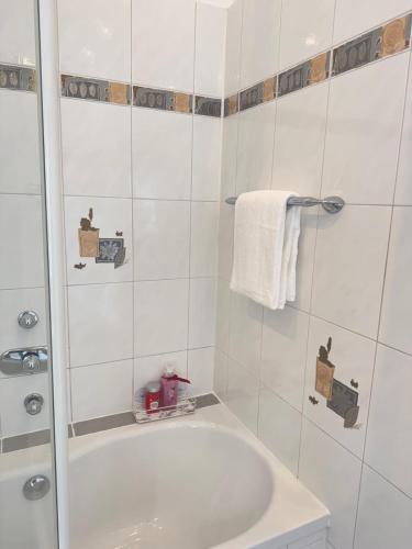 a white bathroom with a tub and a sink at Mahesars Home 2 in Ennepetal