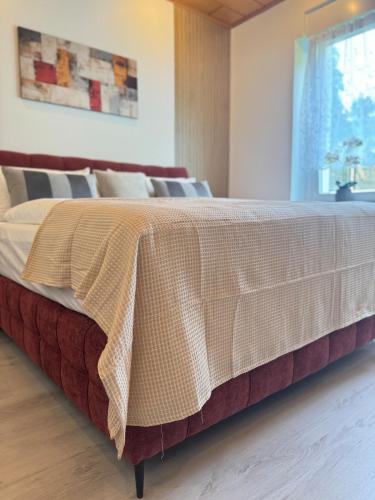 a bed in a room with a blanket on it at Mahesars Home 2 in Ennepetal