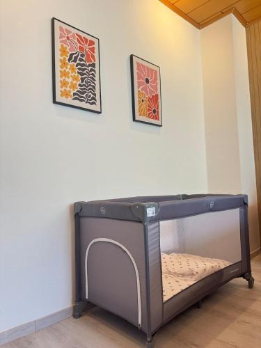 a bed in a room with two pictures on the wall at Mahesars Home 2 in Ennepetal