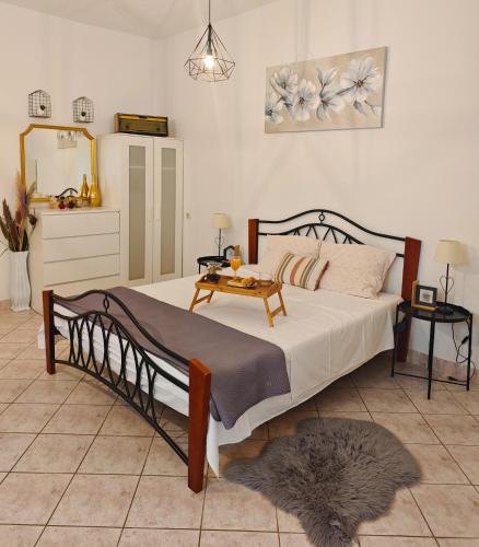 a bedroom with a bed with a table on it at Apartments Marija Karlobag in Karlobag