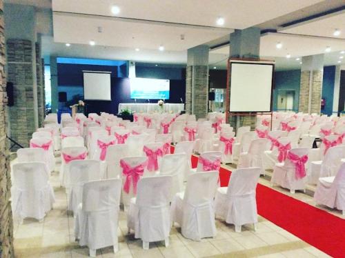 a room filled with white chairs with pink bows at Seaview 1Bedroom 1Bathroom 33Sqm Floor14th Pattaya FO in Jomtien Beach