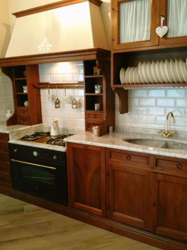 a kitchen with a stove and a sink at La Valinfiore Charming Home in Montecarlo