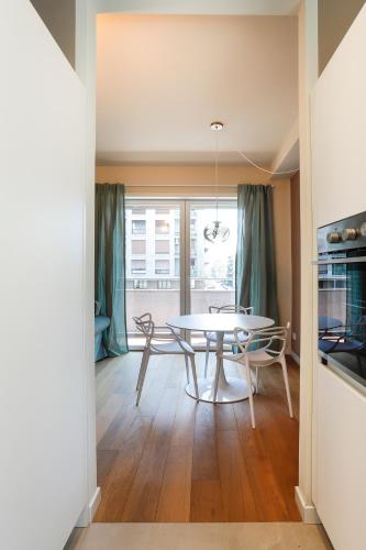 a dining room with a table and chairs at MilanLife Apartments - DTown Charme in Milan
