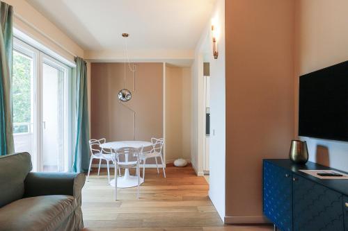 a living room with a table and chairs and a couch at MilanLife Apartments - DTown Charme in Milan