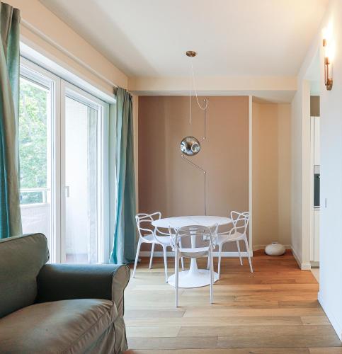 a living room with a table and chairs at MilanLife Apartments - DTown Charme in Milan
